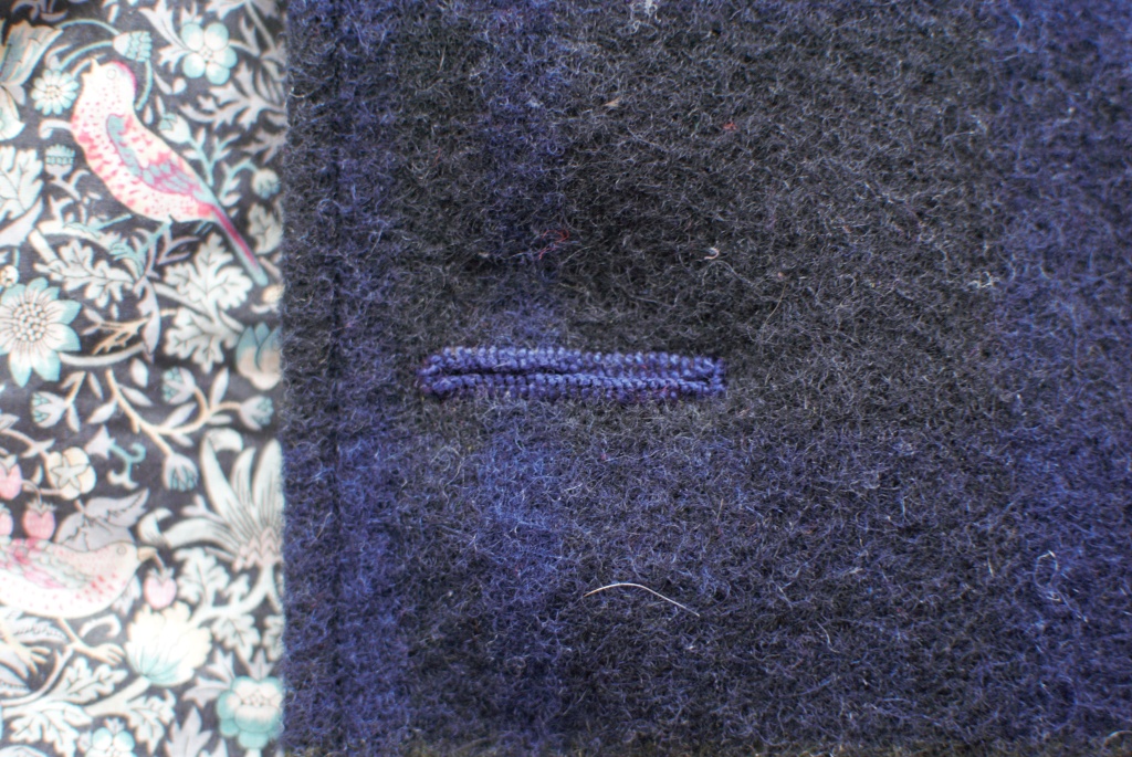 Close up of a hand stitched buttonhole